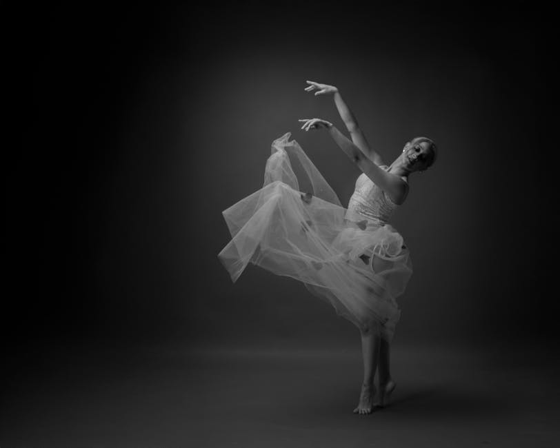 Graceful ballet dancer elegantly posed in motion, creating a delicate and artistic visual in black and white.