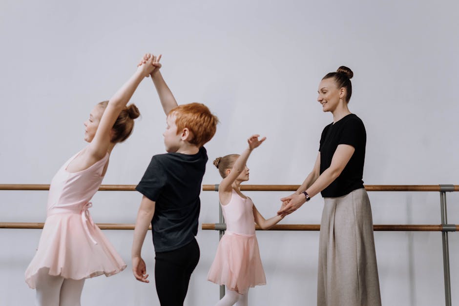 Kids practicing ballet with their instructor in a dance studio, fostering teamwork and learning.