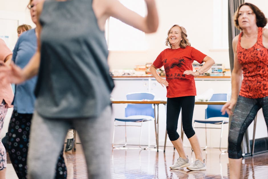 A vibrant dance class indoors with smiling women, encouraging a healthy lifestyle.